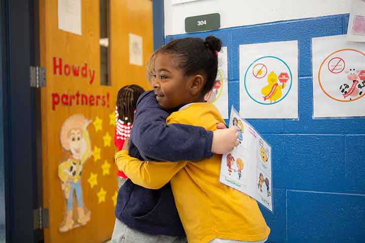 Young boy and girl giving each other a hug.