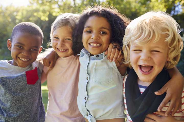 Four kids hanging out together on the playground