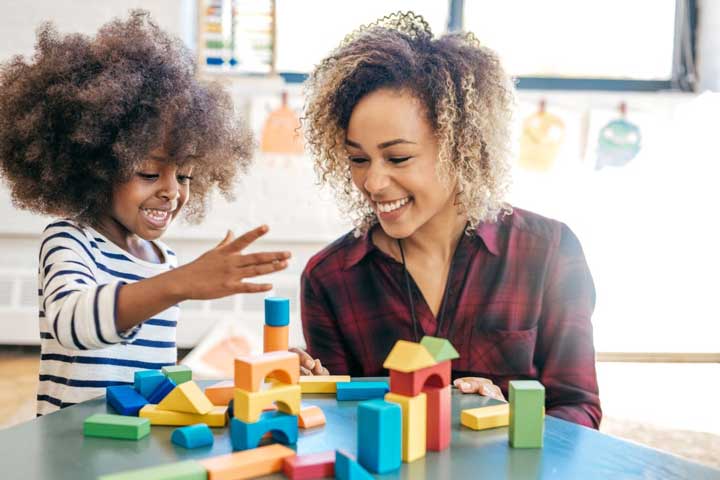 Teacher and child building with blocks