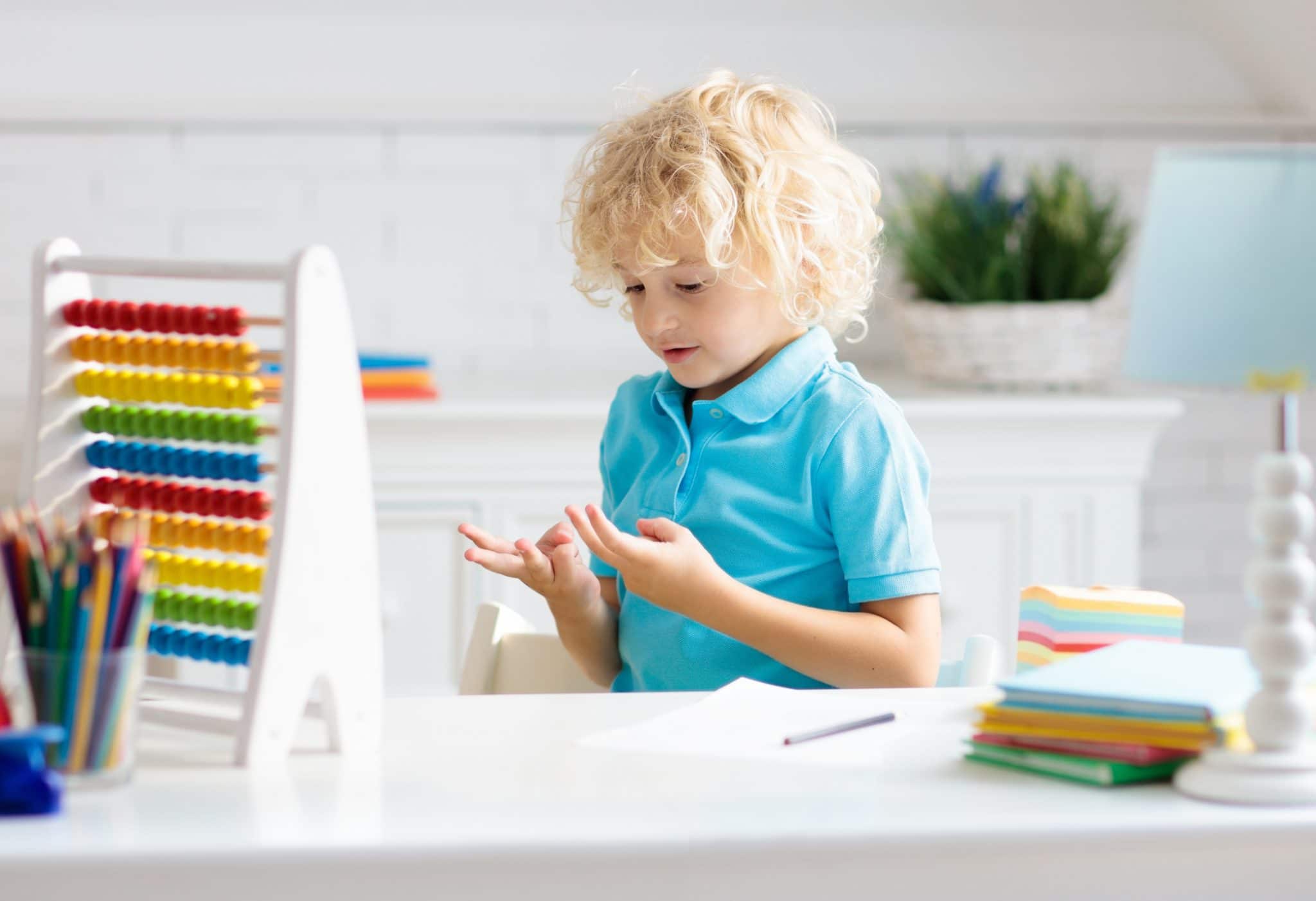 Child with abacus counting on fingers