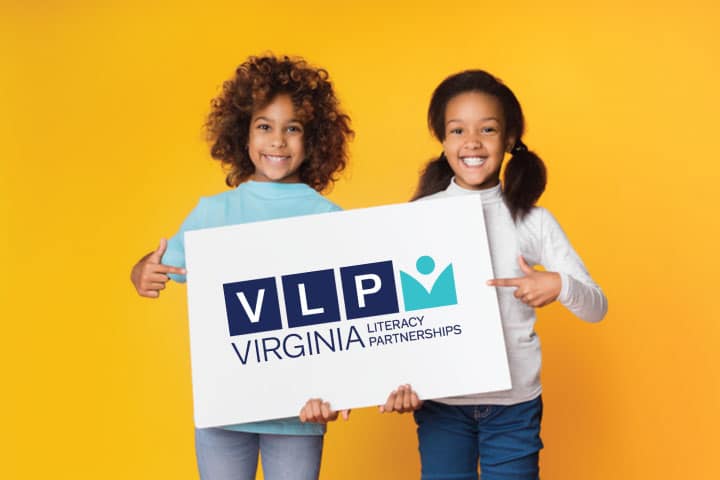 Two children hold sign with VLP logo