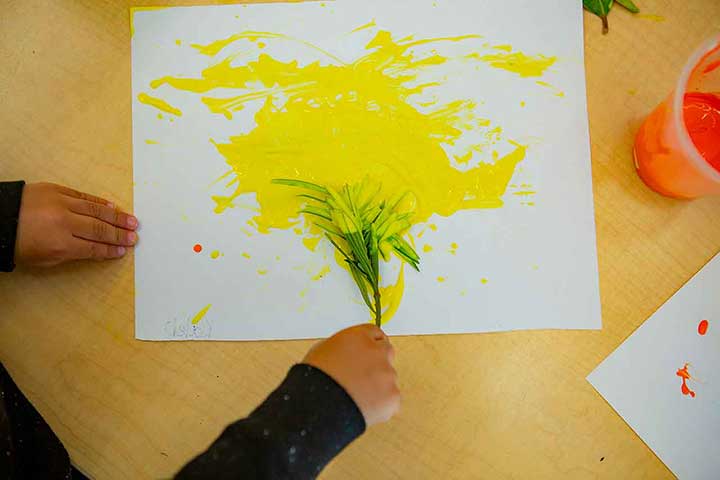 A child drawing art with a leaf