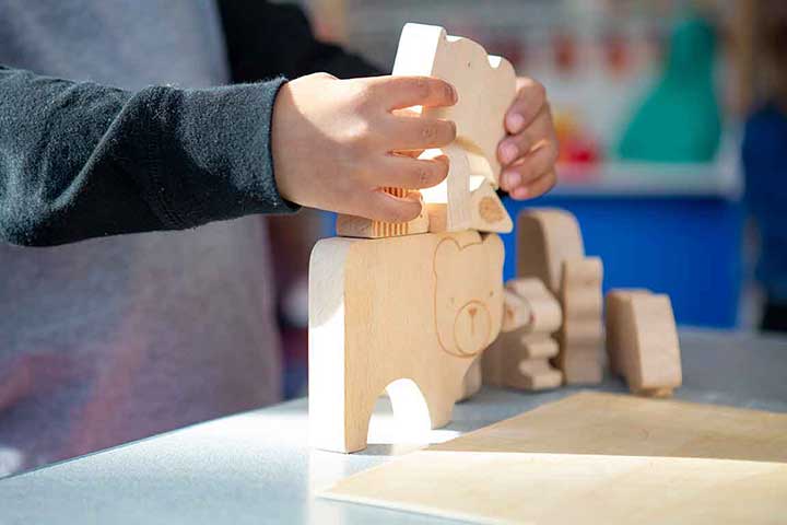 a child hand's holding building blocks